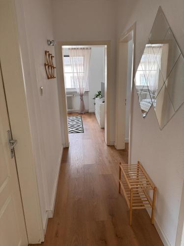 a hallway with a mirror and a wooden floor at Stadtnest Mayen - stilvoll & zentral in Mayen