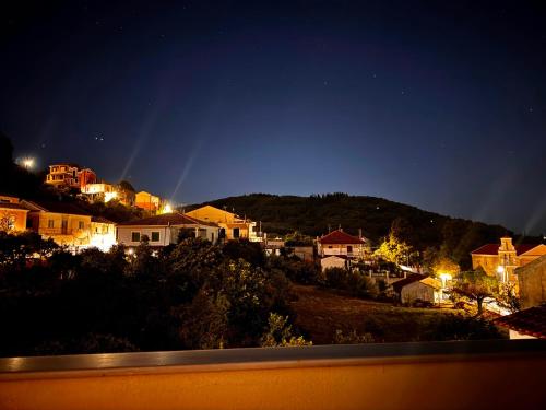 a group of houses on a hill at night at Stablus in Págoi