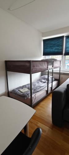two bunk beds in a room with a table at 2 Room Apartment in Randers C in Randers