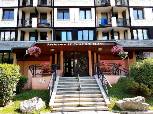 a building with stairs in front of a building at Le Chamois 5E Balcon panoramique MontBlanc avec parking gratuit in Chamonix-Mont-Blanc