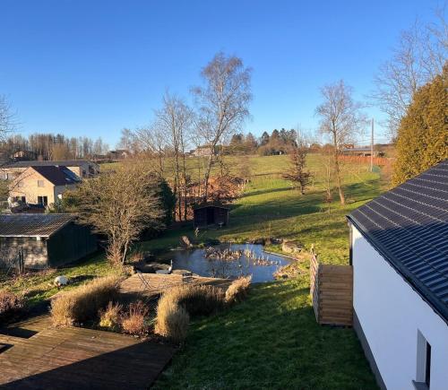 a view of a river with ducks in a yard at Maison Lesve in Profondeville