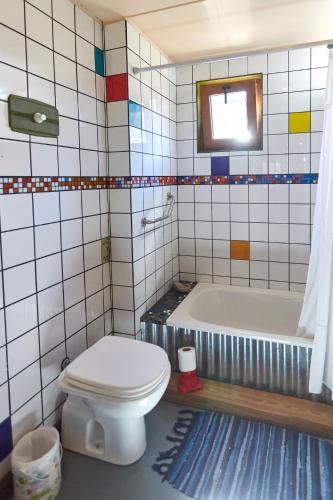 a bathroom with a toilet and a bath tub at CasaAndina Chalten in El Chalten