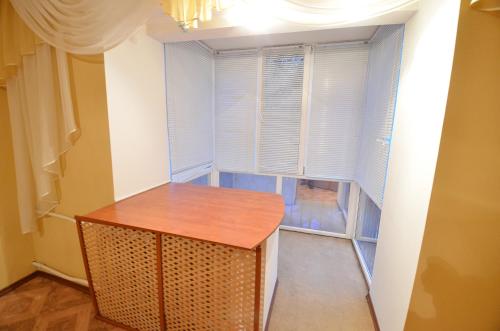 a room with a table in front of a window at Apartment Style on Sobornaya Street in Mykolaiv