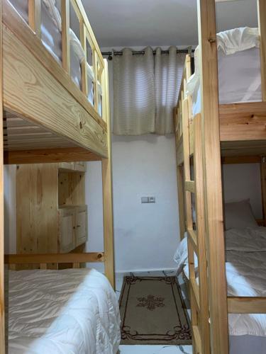 a bedroom with two bunk beds and a bed at Adar guest house in Agadir