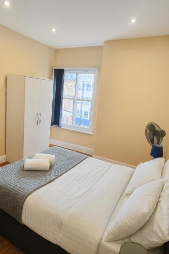 a bedroom with a large bed and a window at Cozy Modern 1 Bed Flat Walsall Town Centre in Walsall