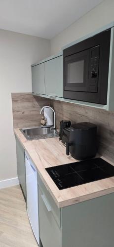 a kitchen with a sink and a microwave at Breagha Cabin, Spean Bridge, near Fort William in Spean Bridge