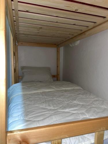 a bed in a small room with a wooden ceiling at Adar guest house in Agadir