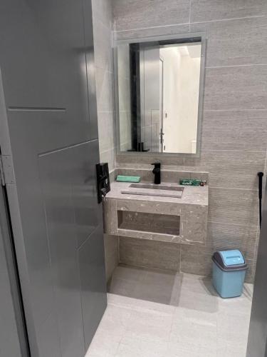 a bathroom with a sink and a mirror at Summo bilding in Jeddah