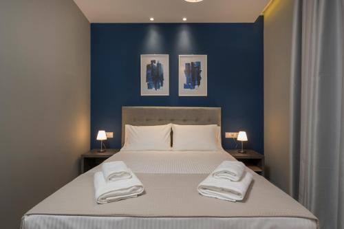 a bedroom with a large bed with two towels on it at Mirma City apartment2 Old Town in Chania