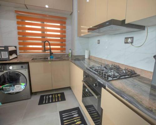 a kitchen with a stove and a counter top at Rachels Haven in Lagos