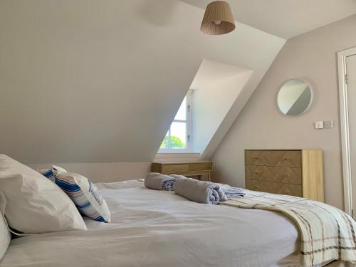 a white bed in a room with a attic at May Cottage in Anstruther