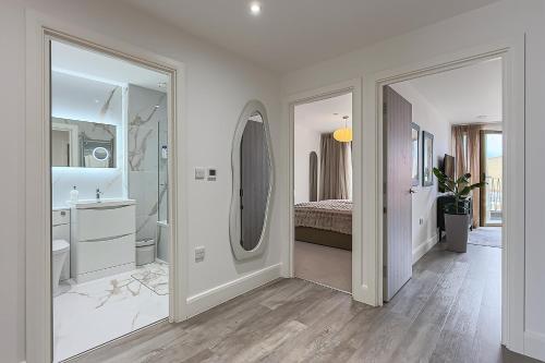 a white bathroom with a sink and a mirror at New in Willesden close to Oxford Str, Wembley, Jubilee line in London