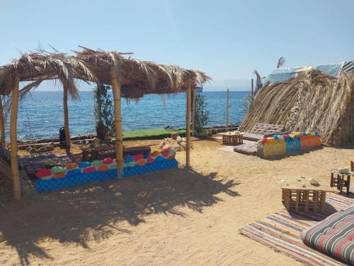 a beach with a play structure on the sand at New Perry's Island in Nuweiba‘ el Muzeinah