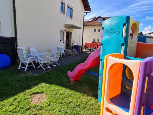 a backyard with a playground with a table and chairs at Ferienhaus Falkenstein mit wunderschönem Bergblick in Frauenau