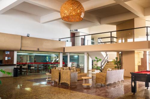 a lobby with a pool table and chairs at HANNA Búzios Al Mare Hotel in Búzios