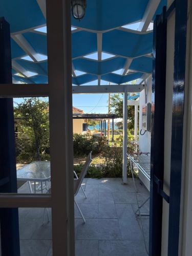 a view of a patio with a blue roof at Jenny Apartments in Karlovasi