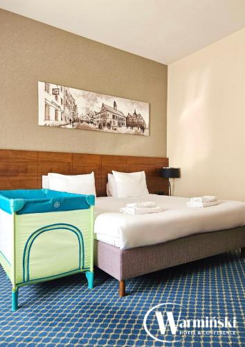 Postel nebo postele na pokoji v ubytování Warmiński Hotel & Conference