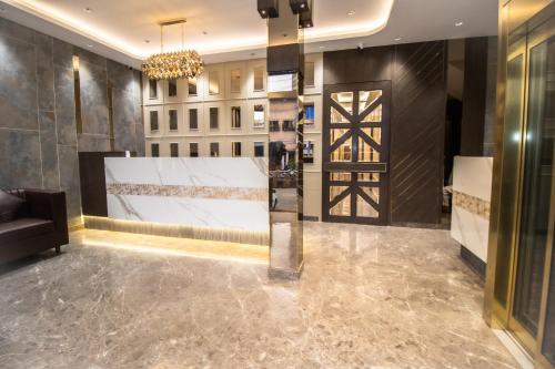 a lobby with a door and a chandelier at Ascent Star Inn in Mumbai