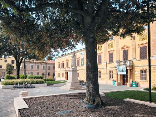 a large building with a tree in front of it at Bellavista Deluxe in Cesena