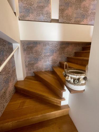 a set of stairs with a basket on the wall at Cortile San Luigi in Capo dʼOrlando