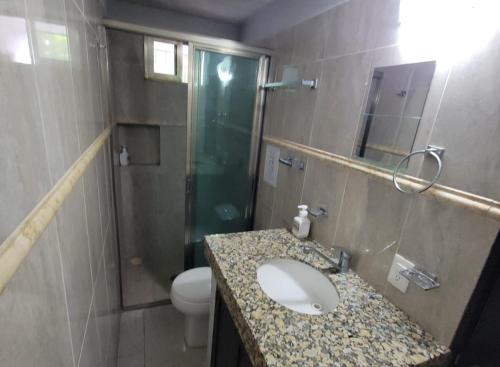 a bathroom with a sink and a shower and a toilet at Saela Hotel Boutique in Playa del Carmen
