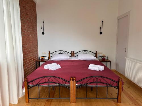 a bedroom with a bed with two towels on it at villa Maiseli in Ambrolauri