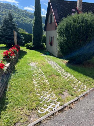 a path in the grass next to a house at Chata v Bučinách in Turnov