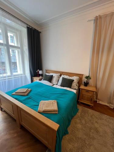 a bedroom with a large bed with blue sheets at štepánská noc B in Prague