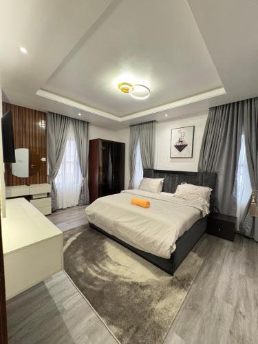 a bedroom with a bed and a television in it at Kirbys Cove in Lekki
