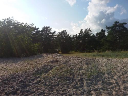 a pile of sand on a field with trees in the background at 6 person holiday home in Ljugarn-By Traum in Ljugarn
