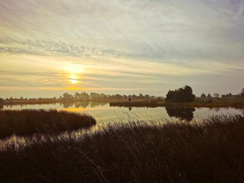 a sunset over a body of water with the sun setting at 5 person holiday home in HALTORP-By Traum in Halltorp