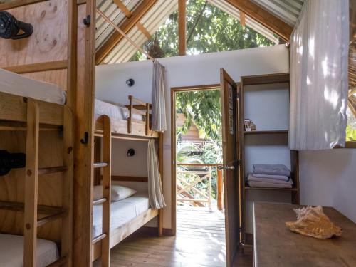 a room with bunk beds in a tree house at Boatique Hotel and Marina in Rio Dulce
