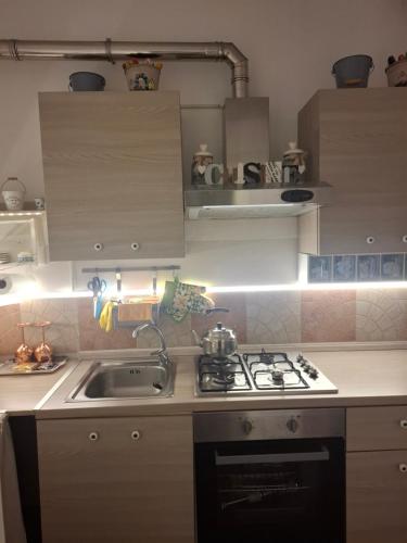 a kitchen with a sink and a stove top oven at Nel Giardino di Carla in Rapallo