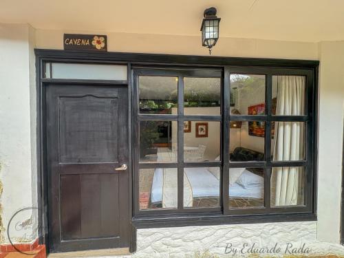 a front door of a building with a window at Hostal Antawara Tayrona in El Zaino
