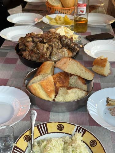a table with two pans of food on a table at Dulović - KATUN POTOCI in Kolašin