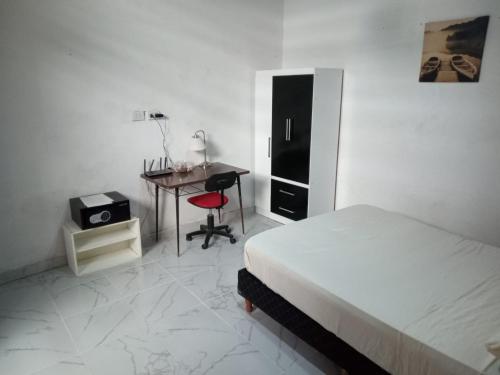 a bedroom with a bed and a desk and a table at Casa en Chacarita in Buenos Aires