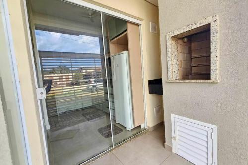 a glass door to a balcony with a view at Firenze Beach House AP101 - 500m da Praia + Wifi in Navegantes