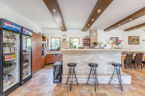 a bar in a kitchen with stools in front of a counter at Penzion Šejby in Horní Stropnice