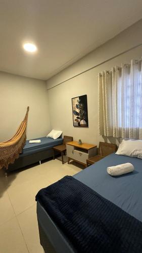 a hotel room with two beds and a couch at Comfortable house in Pedreira in Belém