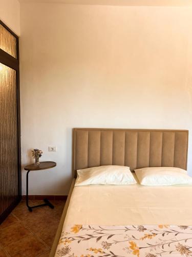a bedroom with a bed and a small table at Aparments Ardi in Orikum