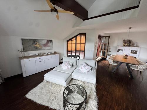 a living room with a couch and a table at Deluxe Maisonette Ferienwohnung in Köditz