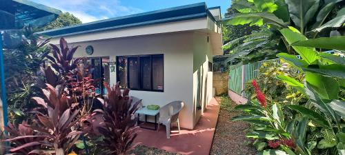 a small house with a table in the garden at Casa Uvita Bay in Uvita