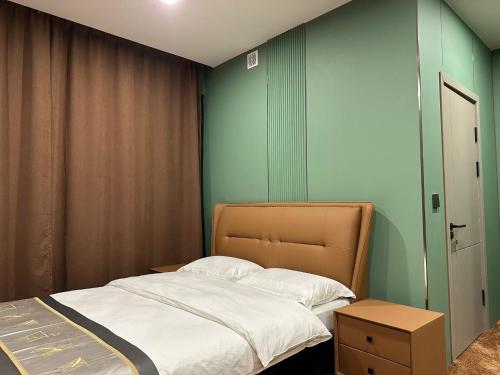 a bedroom with a bed and a green wall at Hotel Balbi Resort in Mendoza