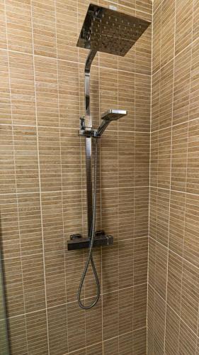 a shower with a shower head in a bathroom at Maple Beach Residences Punta Cana in Punta Cana