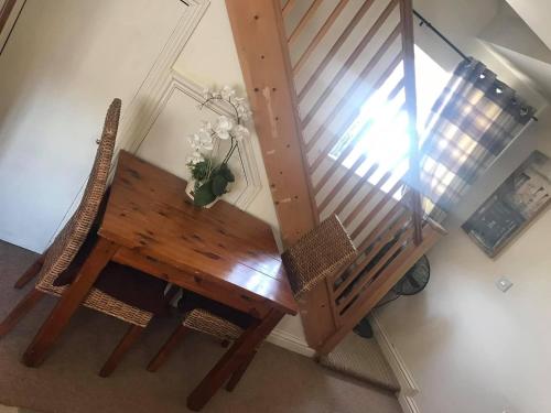 a wooden table and chairs next to a staircase at The Mansion House Hotel in Holbeach