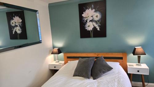 a bedroom with a bed with two nightstands and two lamps at Haybow Farm Accommodation in Rolstone