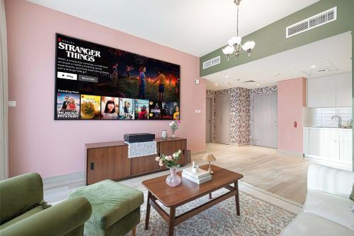a living room with a couch and a table at its the 90s - 120 inch screen in Yas Island