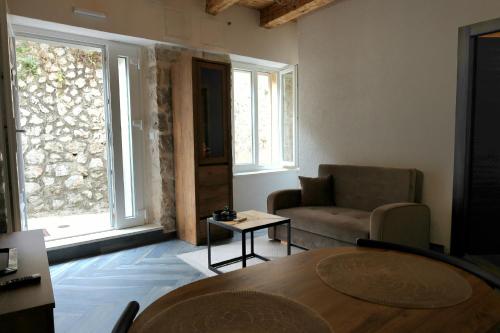 a living room with a table and a couch at Apartments Florian in Lopud Island