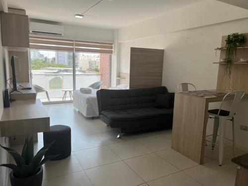 a living room with a couch and a table in it at ZONA VIP elegante y comodo APARTAMENTO FAMILIAR CON BALCON y hermosa vista a la calle, canal isuto zona equipetrol in Santa Cruz de la Sierra