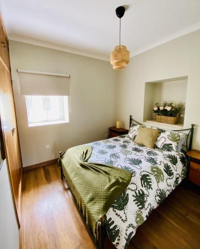 a bedroom with a bed and a window at Casa De Campo Natureza in Porto de Mós
